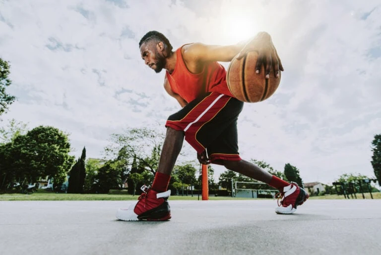 Basketball player doing between the legs.