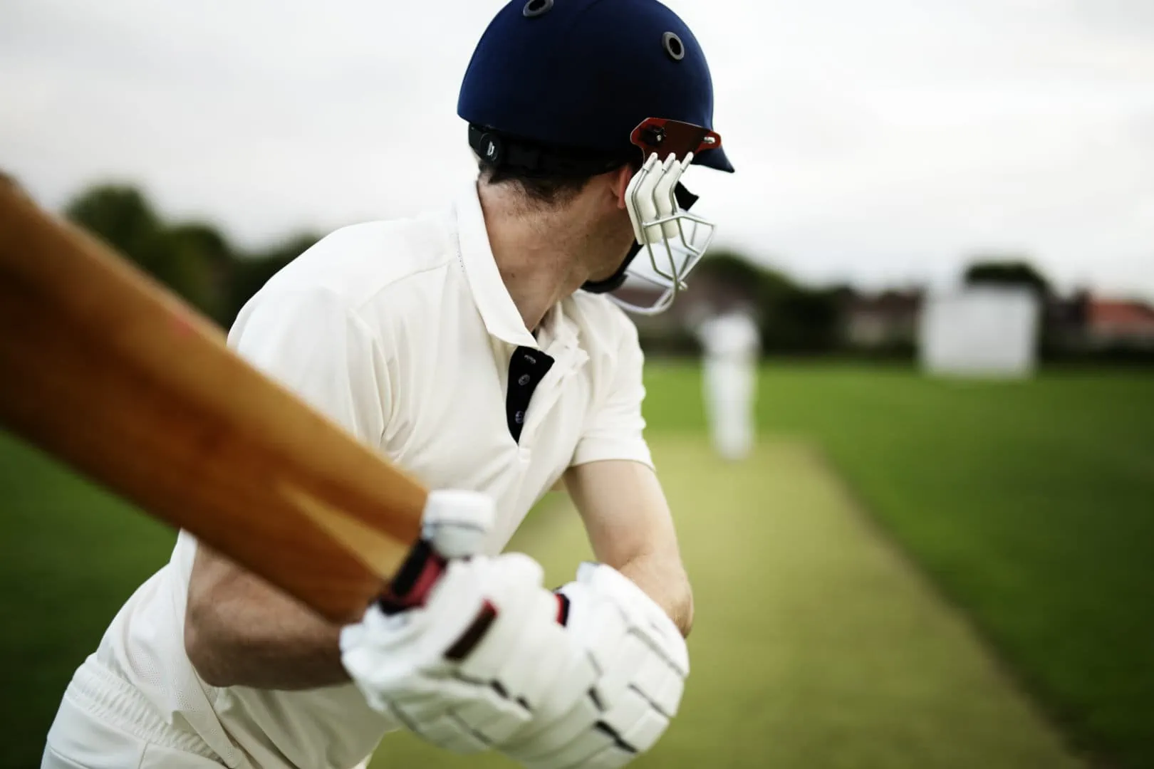 A man about to swing a cricket bat.