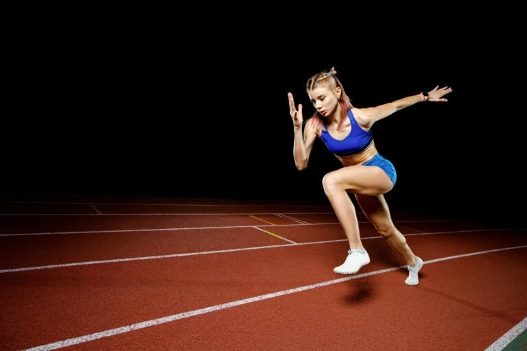 Woman running on a track.